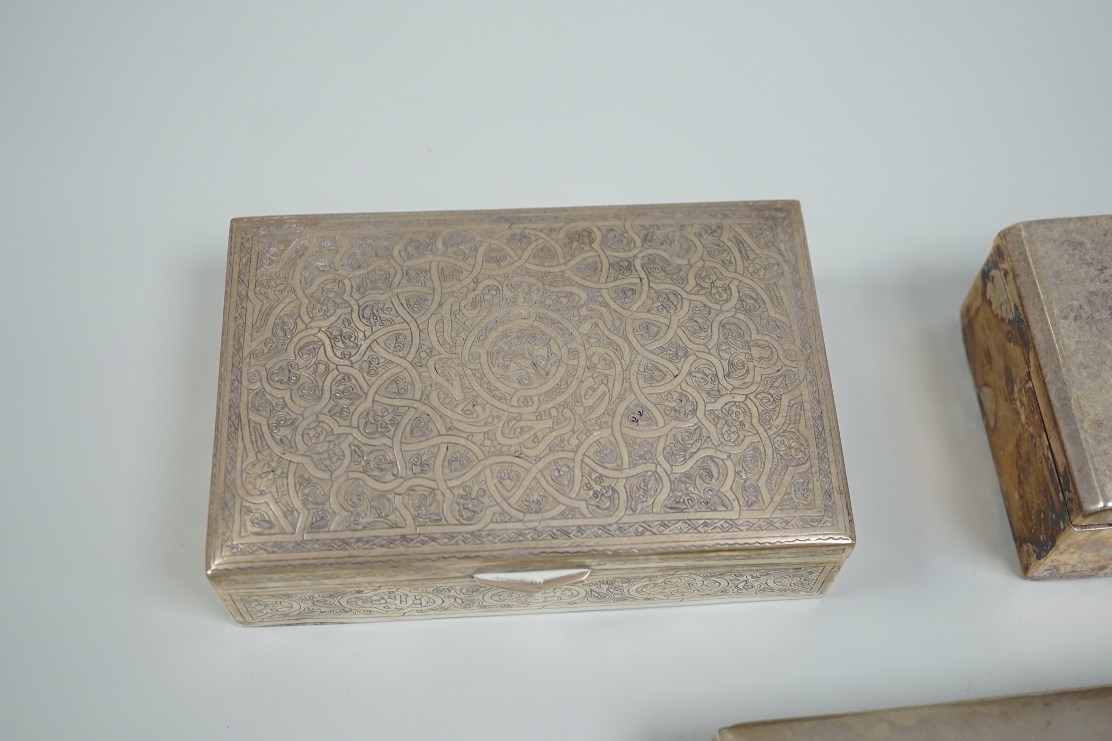 A George V silver mounted cigarette box, 13.9cm, a Persian engraved white metal cigarette box and one other cigarette box.